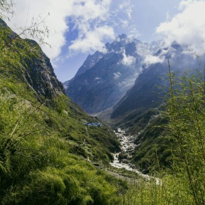 A breathtaking view of the lush green valleys and towering peaks of Annapurna, Nepal.